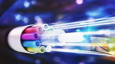 Cutaway view of a fiber optic cable with multiple colored fibers transmitting light.