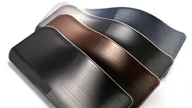 A row of curved brushed metal samples in black, bronze, and silver.