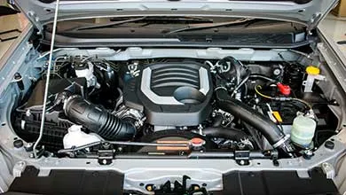 Close-up of a clean, modern car engine with the hood open.