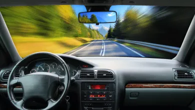 Close‑up view of a car engine compartment with black molded plastic components.